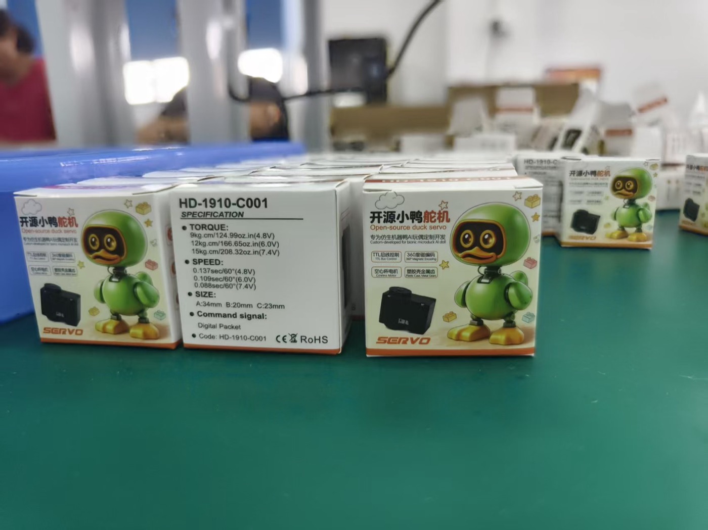 Boxes of Feetech HD-1910-C001 servos on a bench
